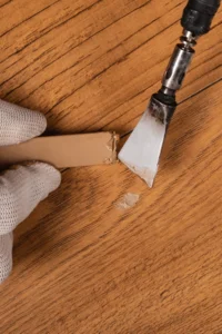 image of a person touching up a hardwood floor