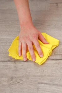 how to remove paint spots from hardwood floors hand washing floor with yellow microfiber cloth