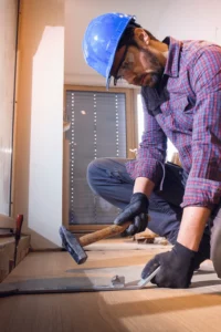 image of a hardwood floor professional installing hardwood floor in a home