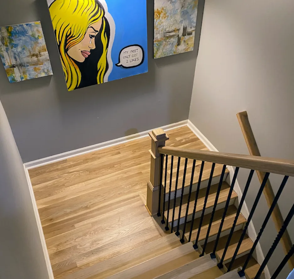 White oak hardwood stair installation with iron balusters in an Alpharetta, GA foyer