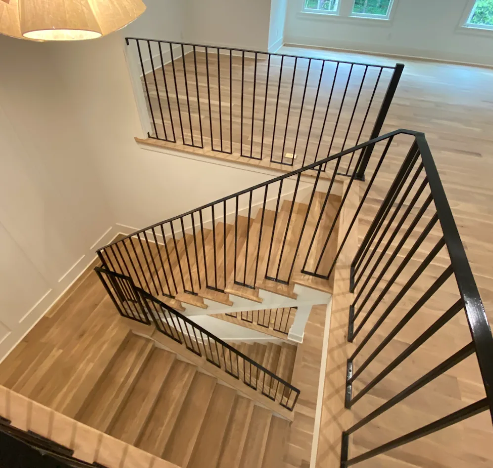 Curved white oak hardwood staircase installation in an Atlanta, GA home