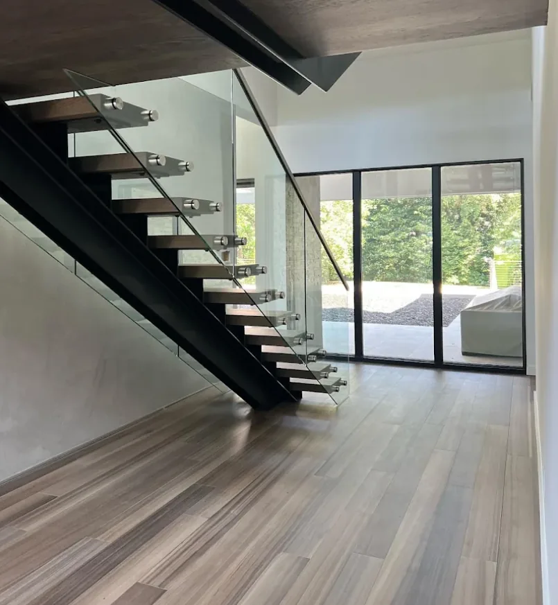 Floating hardwood staircase with glass railing in a modern Buckhead, GA home