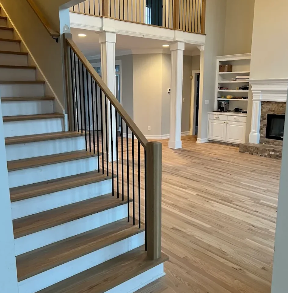 White oak hardwood stair installation with iron balusters in a Johns Creek, GA foyer