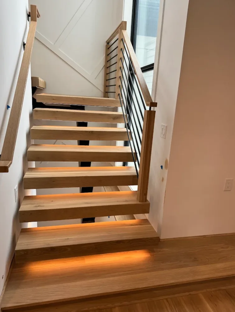 Floating open-riser hardwood staircase with LED lighting in Sandy Springs, GA