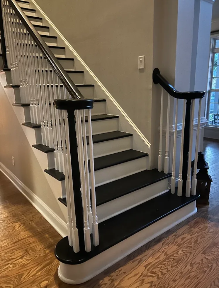 Refinished hardwood stairs with black-painted treads in a Woodstock, GA home